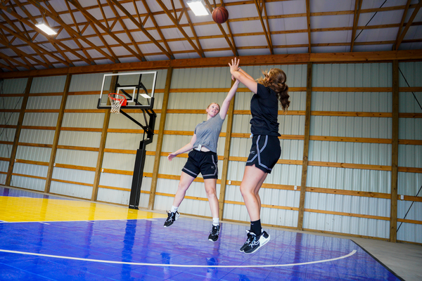 Two Girls Playing Basketball with Goalsetter